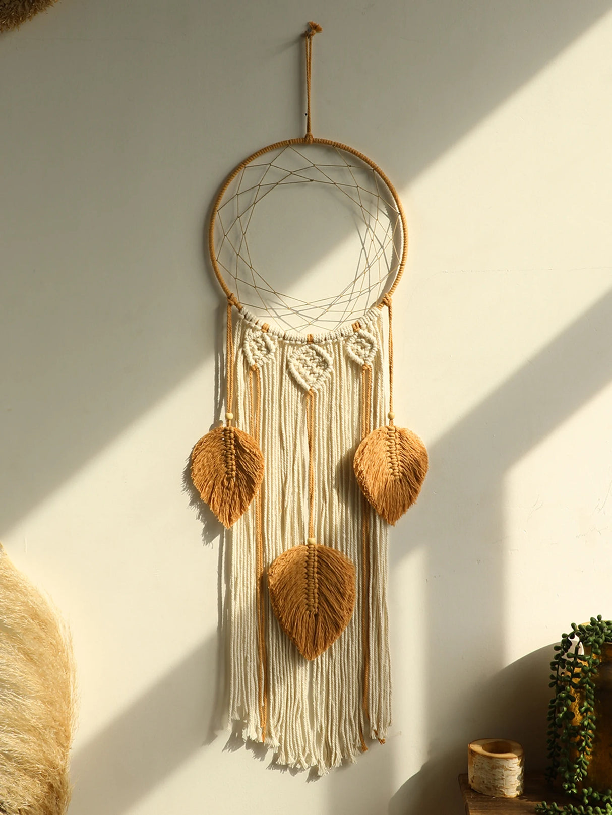 Macrame feather leaf dream catcher hanging for spiritual room decor, bedroom wall styling, and peaceful boho interiors.