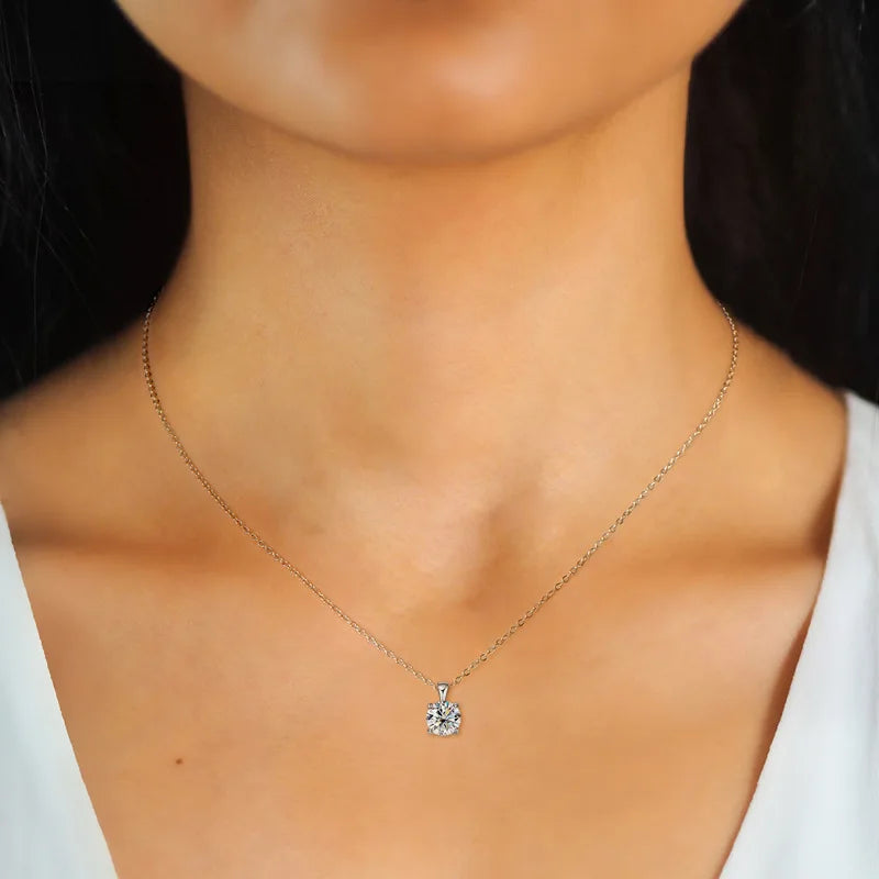 Round moissanite four-prong necklace pendant for sparkling daily wear, date night looks, and gift giving.
