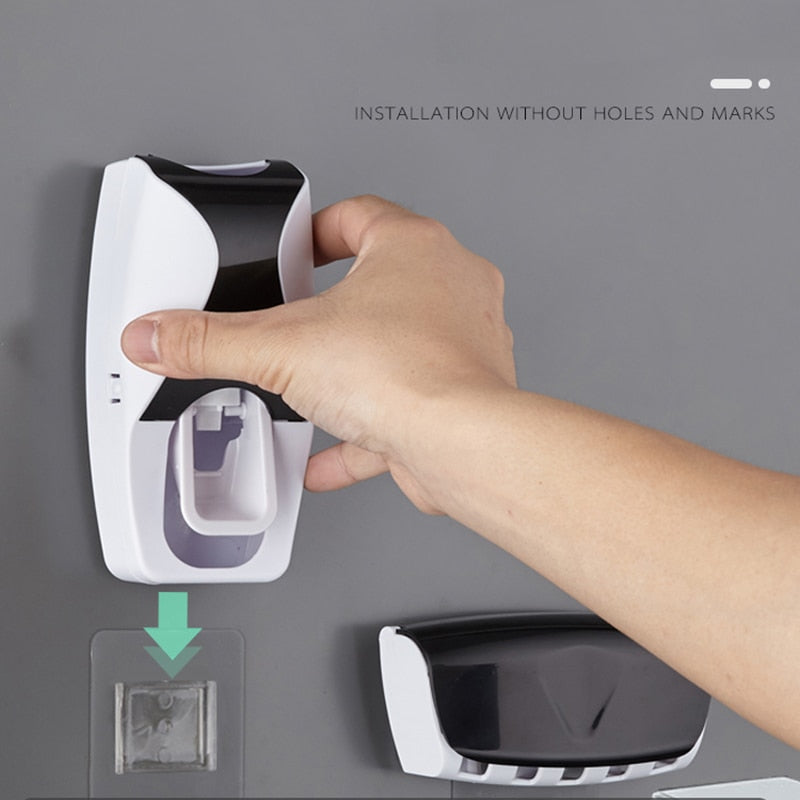 Automatic Toothpaste Dispenser Set installed on bathroom wall with suction cup mounting.