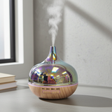 Iridescent diffuser emitting steam on a light surface with a window in the background