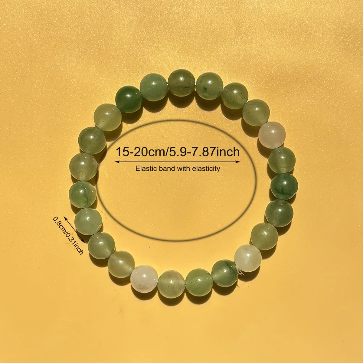 Green beaded bracelet on a yellow background with measurements indicated