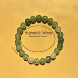 Green beaded bracelet on a yellow background with measurements indicated