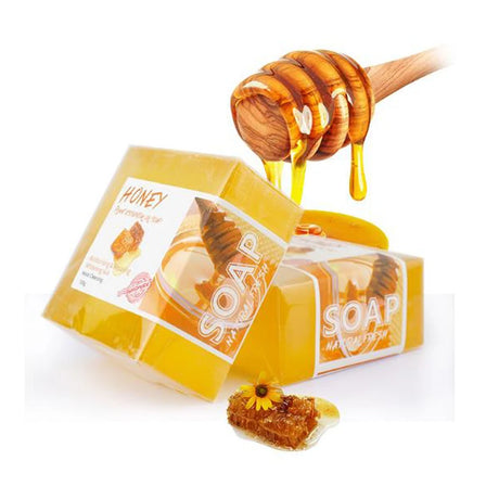 Honey soap with a honey dipper on a white background