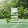 Pstlalae Moringa supplement bottle with leaves on a white background