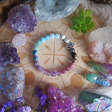 Colorful beaded bracelet on an astrological chart with crystals around