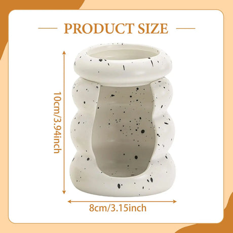 Speckled ceramic pot with dimensions on a peach background