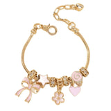 Gold bracelet with pink and white charms on a white background