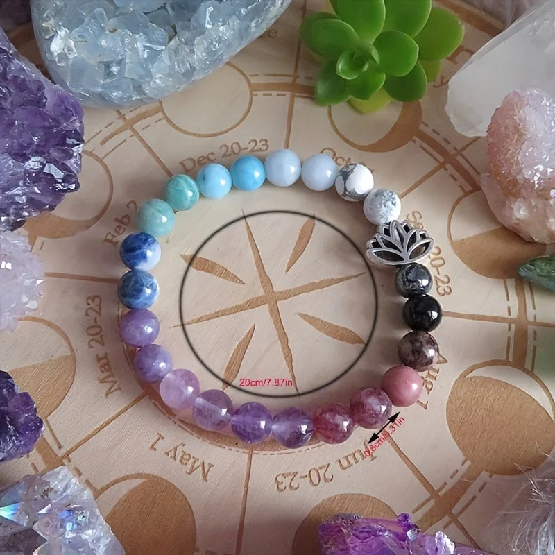 Colorful beaded bracelet on a wooden surface with crystals and plants