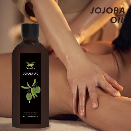 Bottle of Jojoba oil with a person applying it to their skin