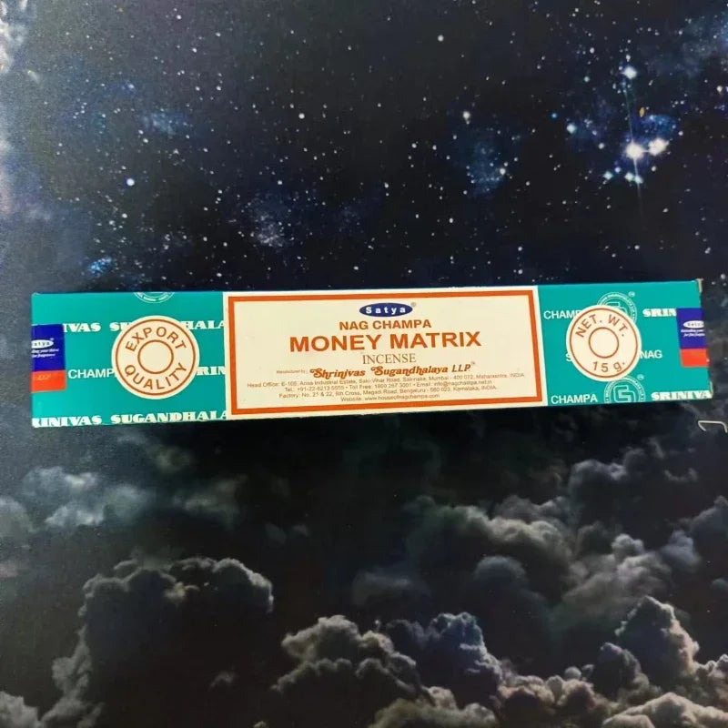 Box of Satya Money Matrix incense on a starry night background