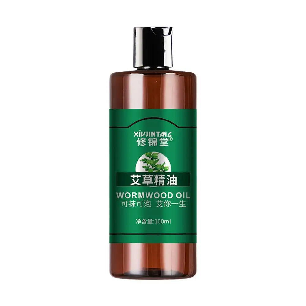 Brown bottle of wormwood oil with green label on a white background