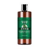 Brown bottle of wormwood oil with green label on a white background