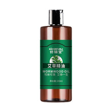Brown bottle of wormwood oil with green label on a white background