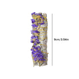 Bundled sage with purple flowers and yellow string on a white background