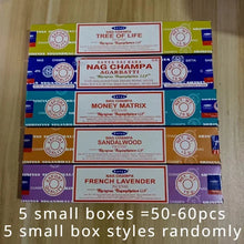Collection of Nag Champa incense boxes on a wooden surface with text indicating quantity and box styles.