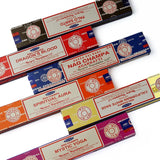 Collection of Nag Champa incense sticks in various packaging on a white background