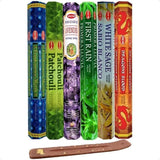 Collection of incense sticks with various scents and a wooden holder on a white background