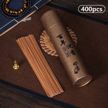 Cylindrical incense container with incense sticks on a brown surface, labeled '400pcs'.