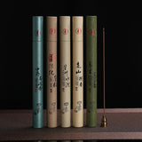 Five incense sticks in cylindrical containers with text and symbols on a dark background