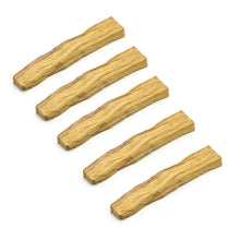Five pieces of dried vanilla wood stick on a white background