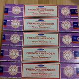 Multiple boxes of Nag Champa French Lavender incense on a wooden surface