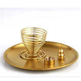 Gold spiral incense burner with accessories on a gold tray