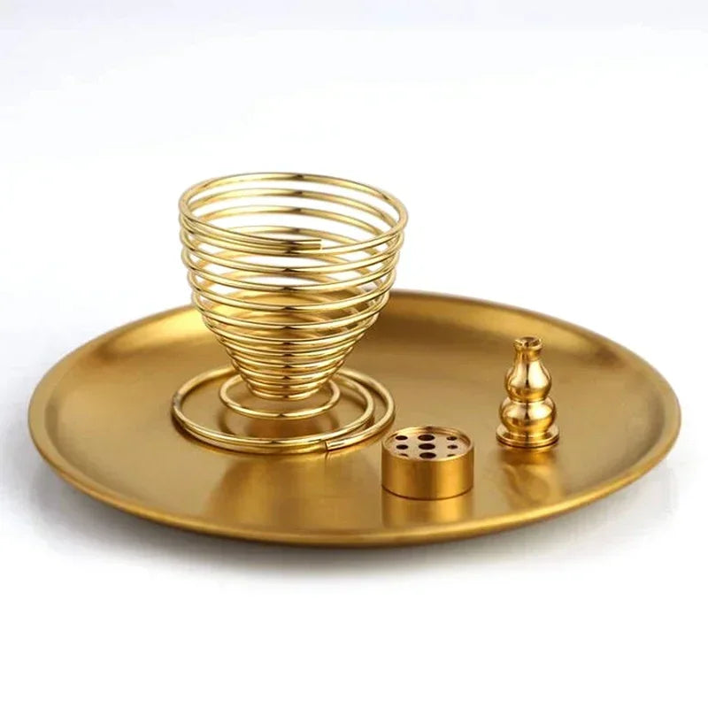 Gold spiral incense burner with accessories on a gold tray