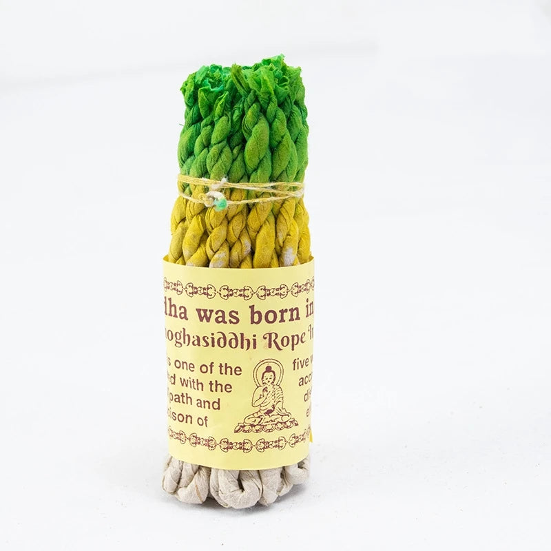 Green and yellow twisted incense rope with a label on a white background