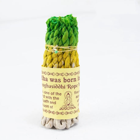 Green and yellow twisted incense rope with a label on a white background