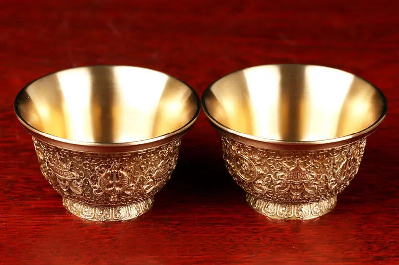 Two gold bowls on a red background with text above them.