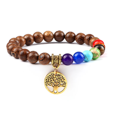 Bracelet with wooden beads and colorful stones featuring a gold tree of life charm on a white background