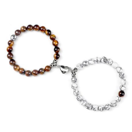 Two bracelets, one with brown beads and silver accents, the other with silver floral design, on a white background.