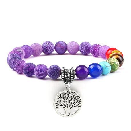 Multicolored beaded bracelet with a silver tree of life charm on a white background