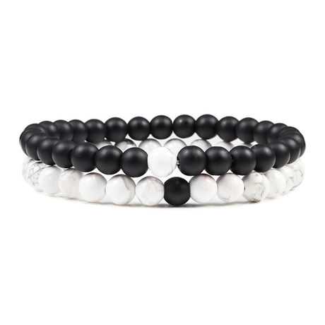 Set of black and white beaded bracelets on a white background