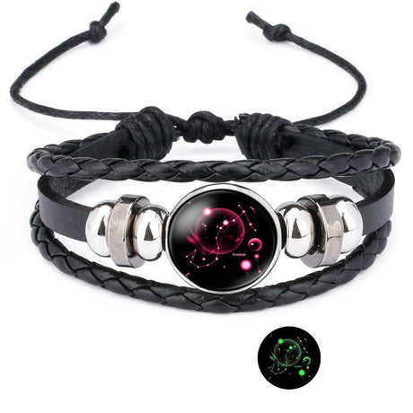 Black braided leather bracelet with a glowing black and pink bead on a white background