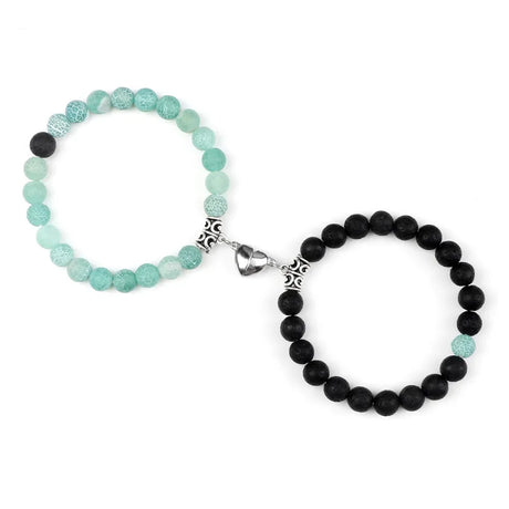 Two beaded bracelets, one green and one black, on a white background