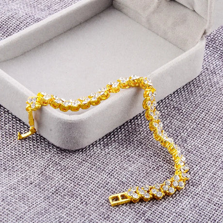 Gold bracelet with diamonds on a textured surface