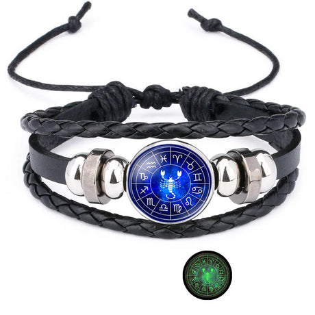 Black braided leather bracelet with silver accents and a blue Scorpio symbol pendant on a white background.