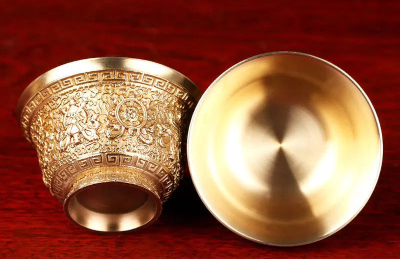 Gold-colored with intricate designs on a red background