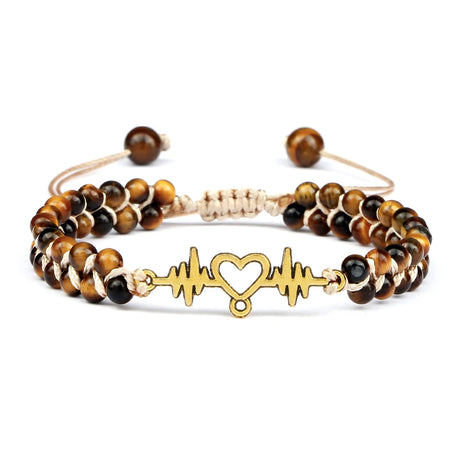 Bracelet with tiger eye beads and gold heart and line design on a white background