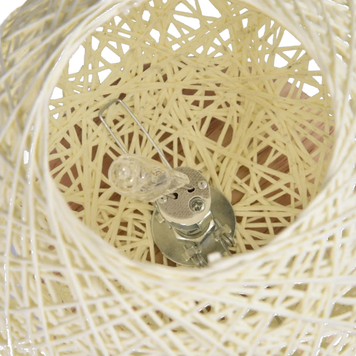 Close-up of a light bulb inside a woven basket