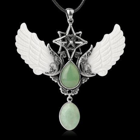 Pendant with wings and green stones on a black background