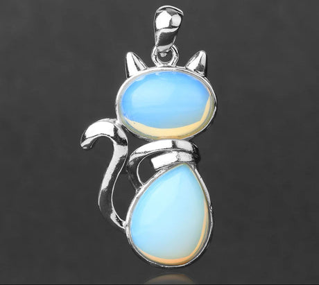 Cat-shaped pendant with blue stone on a dark background