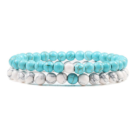 Set of turquoise and silver beaded bracelets on a white background