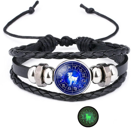 Black braided leather bracelet with silver accents and a blue astrological symbol charm on a white background.