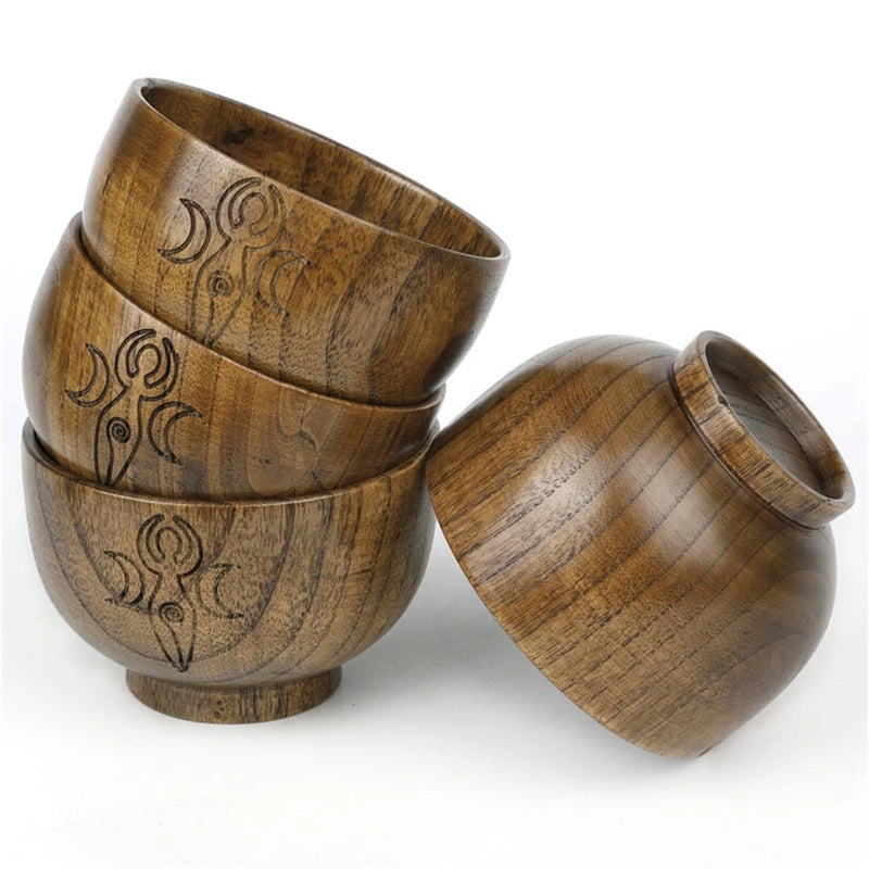 Set of wooden bowls with engraved patterns on a white background