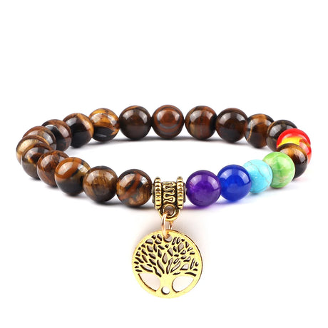Multicolored beaded bracelet with a gold tree of life charm on a white background
