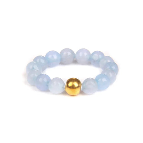 Bracelet with light blue beads and a gold bead on a white background