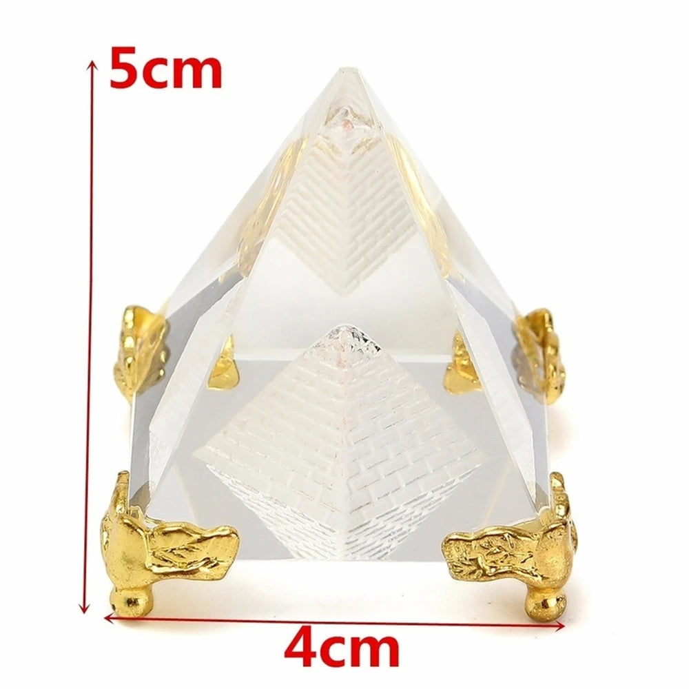 Crystal pyramid with gold bases and measurements on a white background