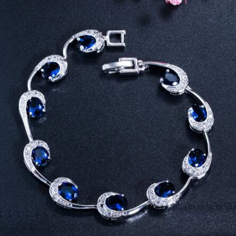 Silver bracelet with blue gemstones on a dark background